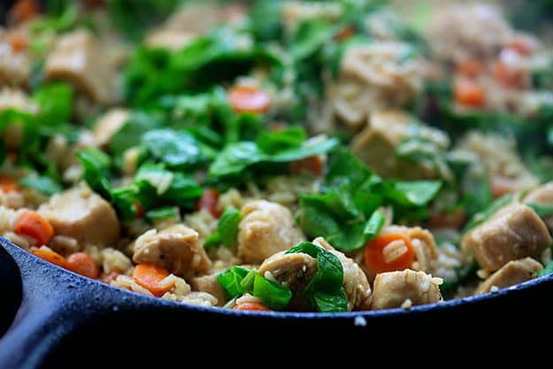 spinach with chicken and rice in skillet