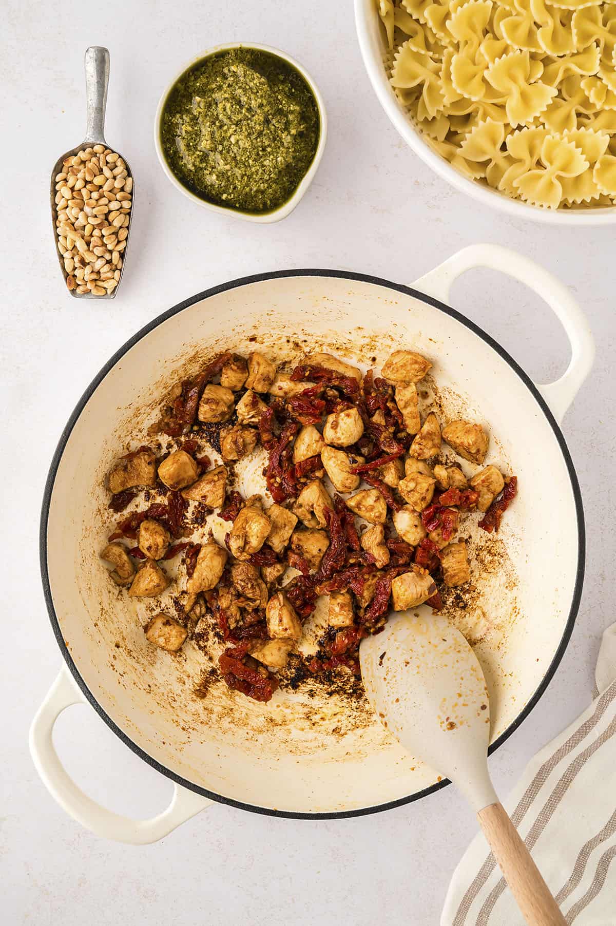 Cooked chicken with sun-dried tomatoes in dutch oven.