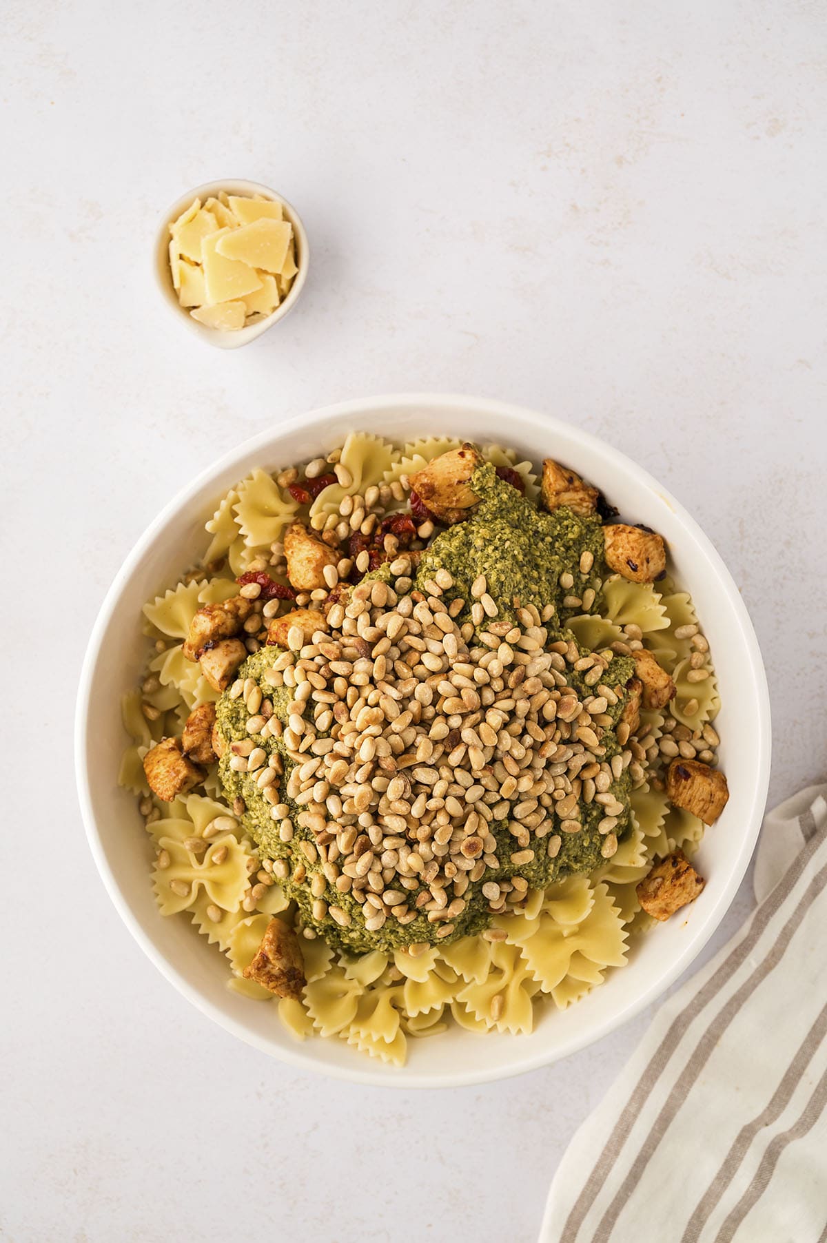 Pasta, chicken, and pesto in bowl.