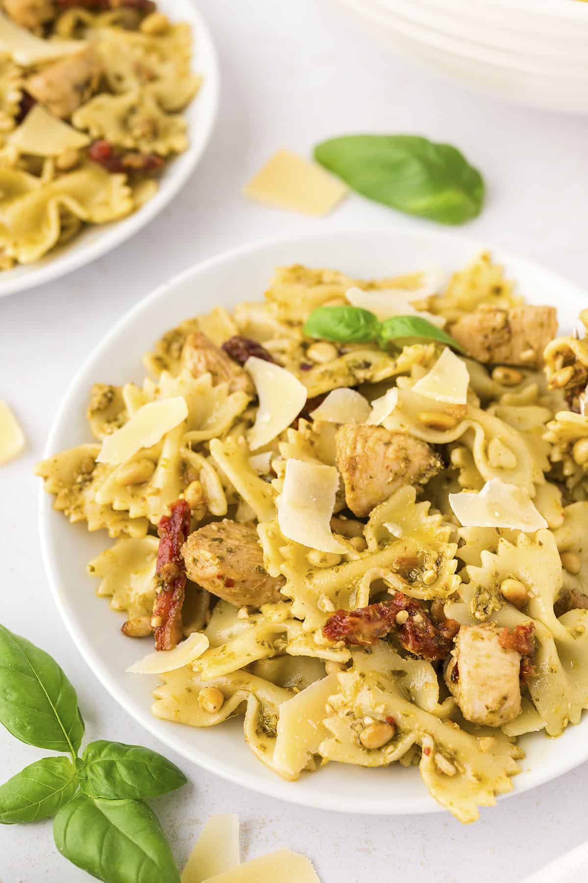 Chicken pesto pasta on small plate.