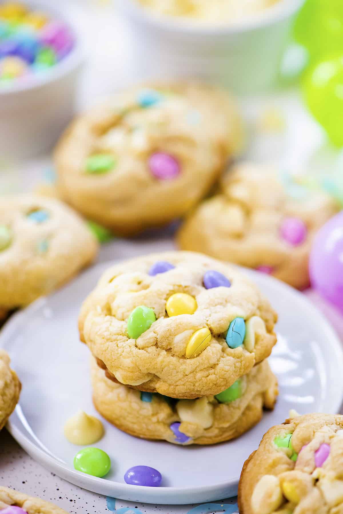 stack of m&m Easter cookies on plate.