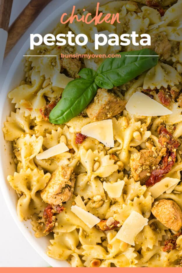 Close up of pesto and chicken pasta in white bowl.