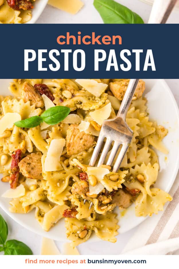 Fork in a bowl of chicken pesto pasta.