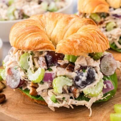 Chicken salad recipe with grapes and pecans on croissant.