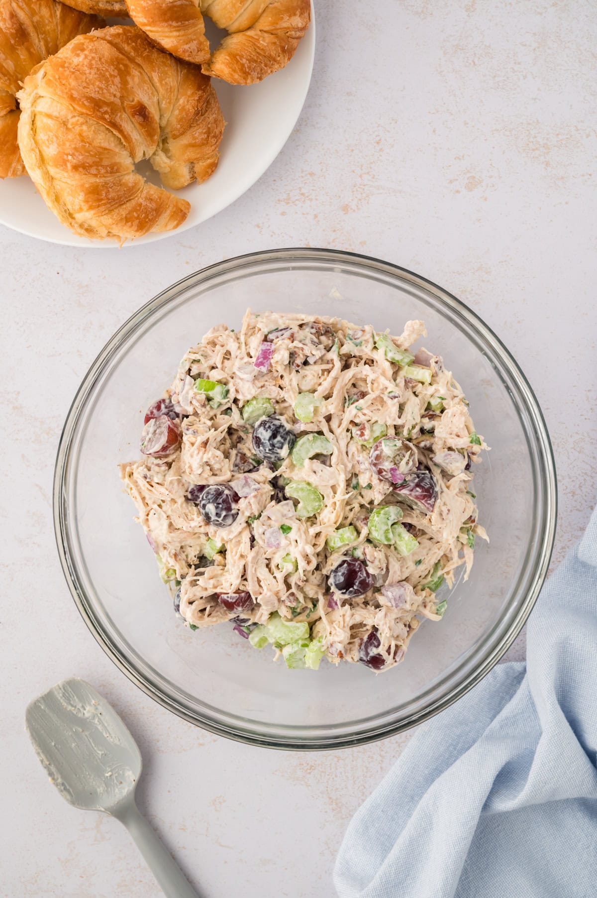Chicken salad in glass mixing bowl.