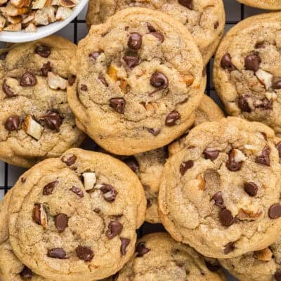 Mini chocolate chip pecan cookies all piled together.