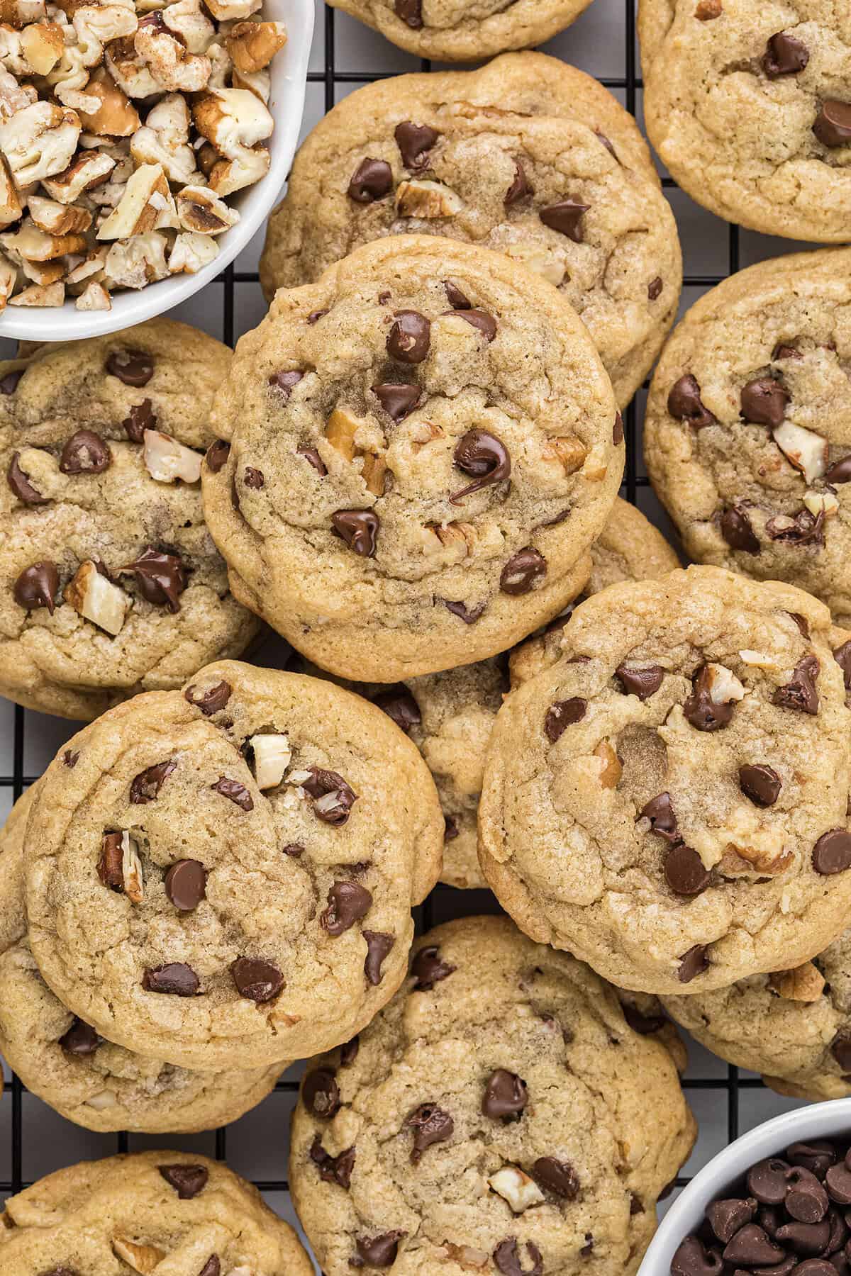 Mini chocolate chip pecan cookies all piled together.