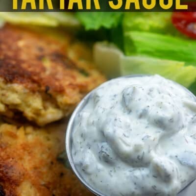 Homemade tartar sauce next to salmon patties.