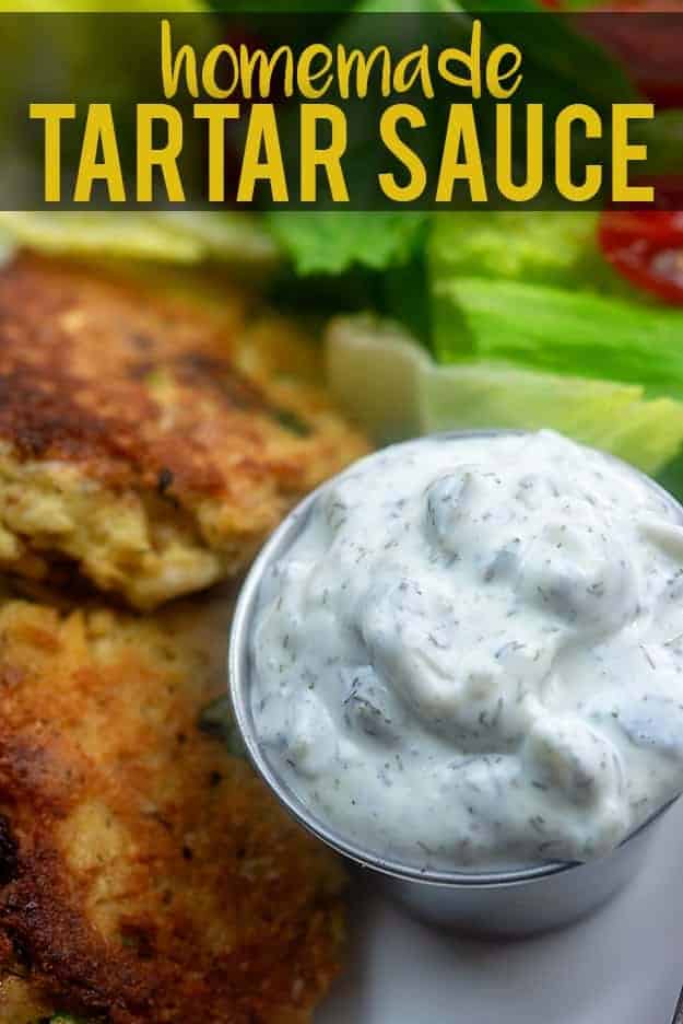 Homemade tartar sauce next to salmon patties.