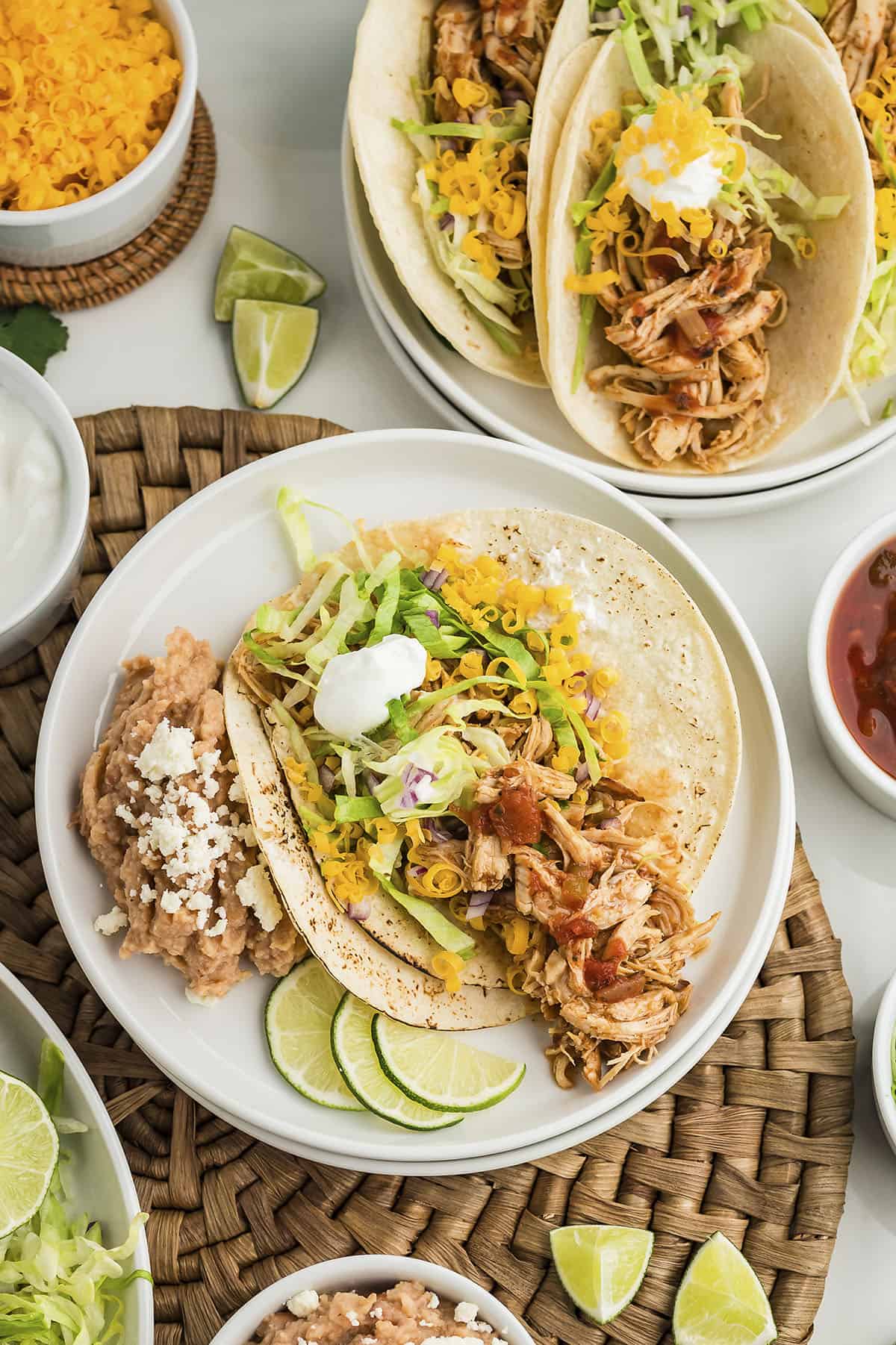 instant pot shredded chicken tacos in corn tortillas with toppings