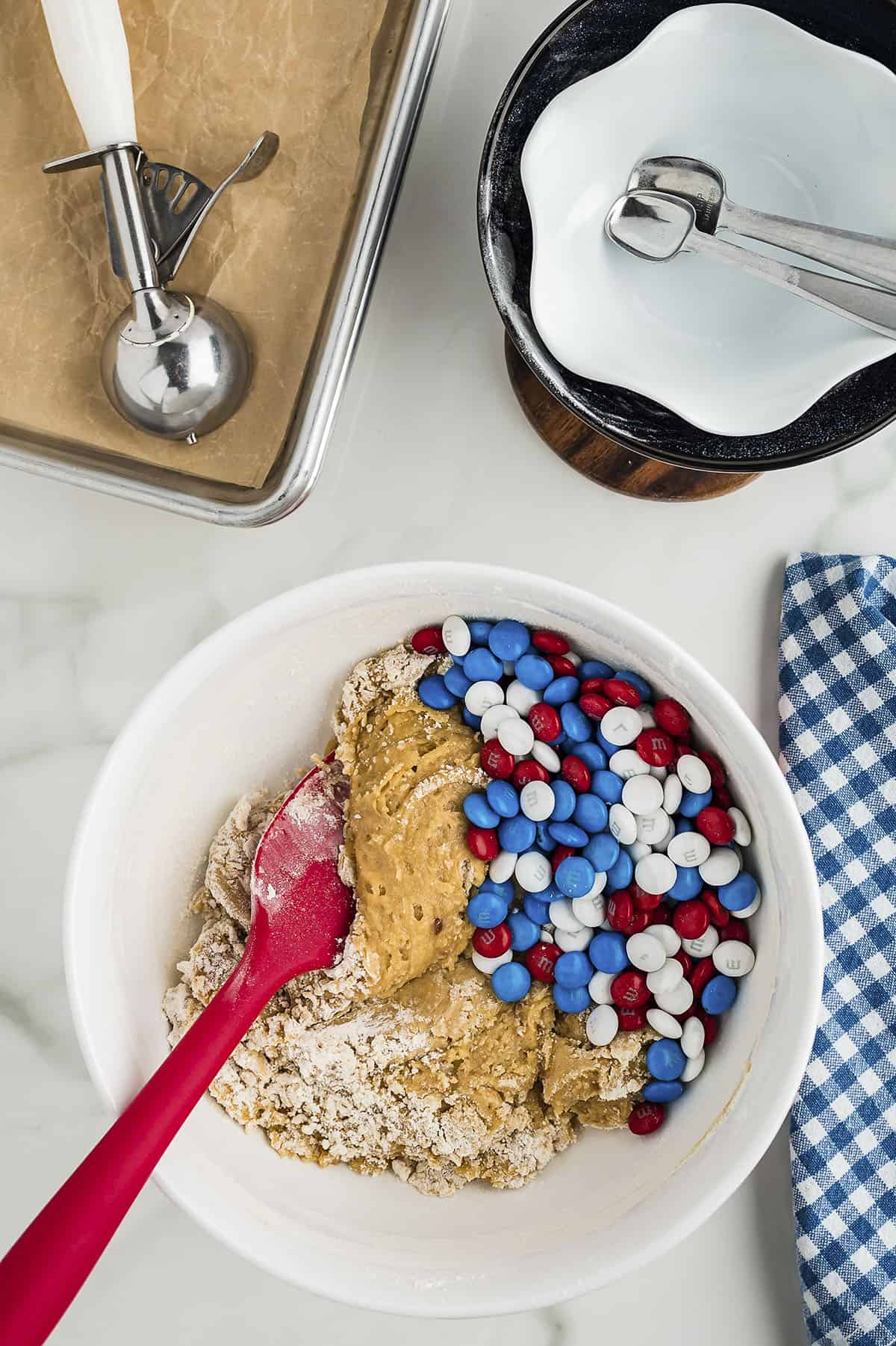 Cookie dough with m&m candies being mixed in.