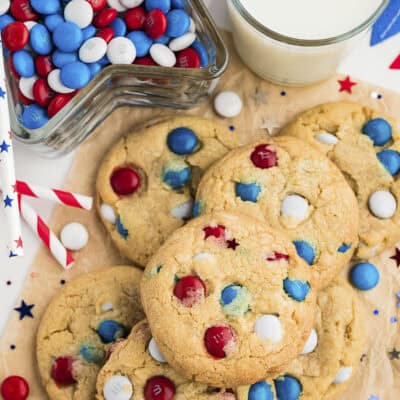 4th of July cookies piled up next to a glass of milk.