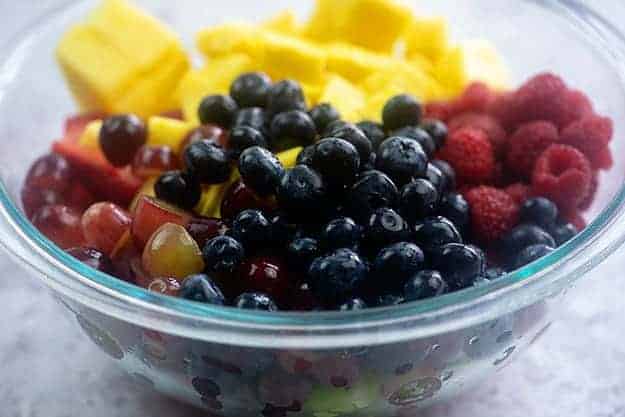 Various fruits in a clear glass bowl.