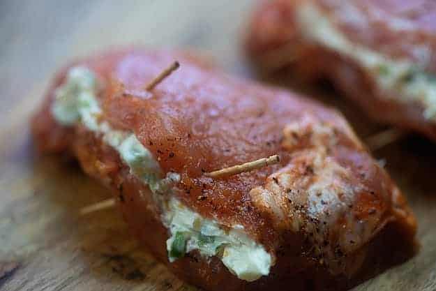 stuffed pork chops on cutting board.