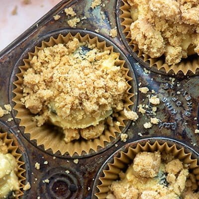 Streusel spread out over a muffin pan.