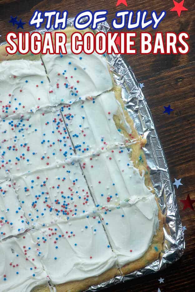Cooked sugar cookie bars cut into squares on a baking sheet.