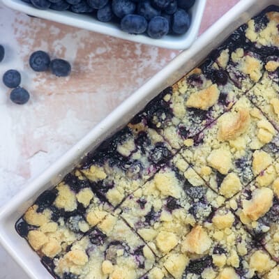 Blueberry bars cut into squares and in baking pan