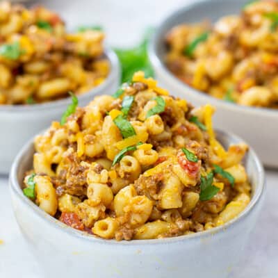 loaded mac and cheese in white bowls.