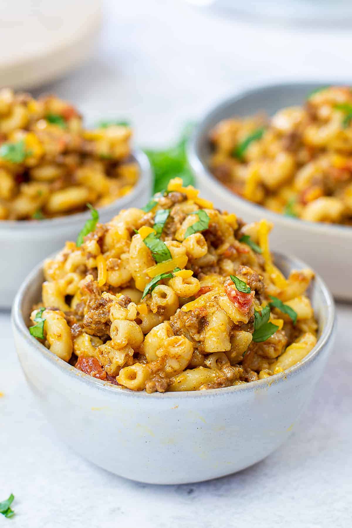 taco mac and cheese piled high in white bowl.