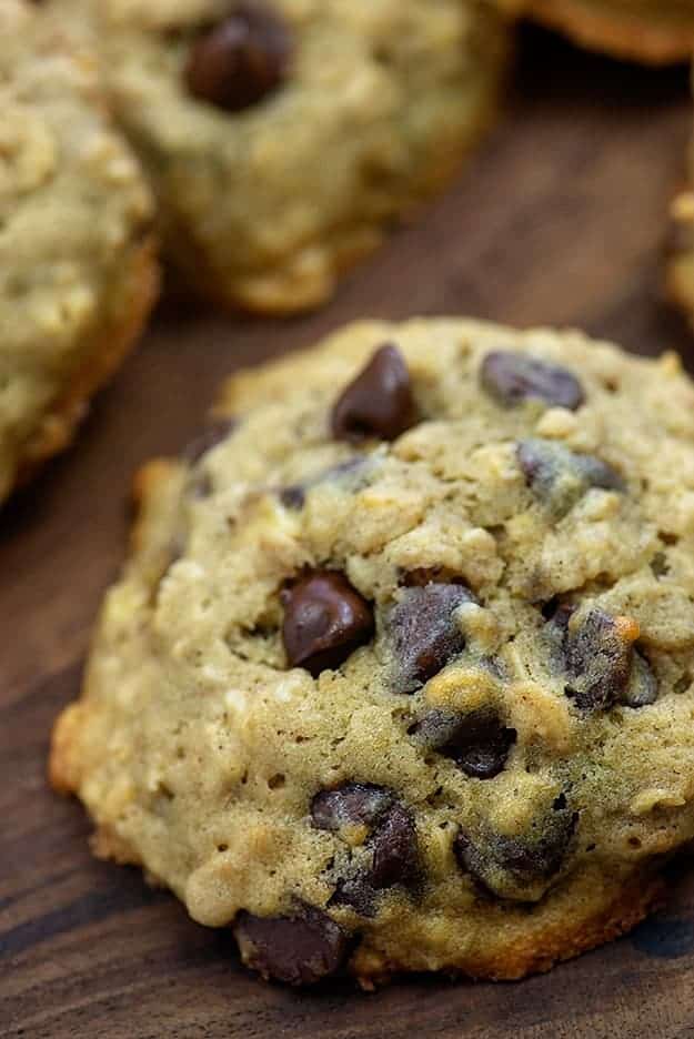 A close up of a chocolate chip cookie on a table.