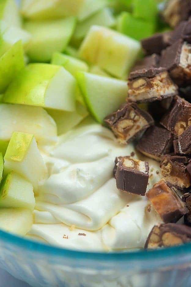 ingredients for snickers apple salad in glass bowl