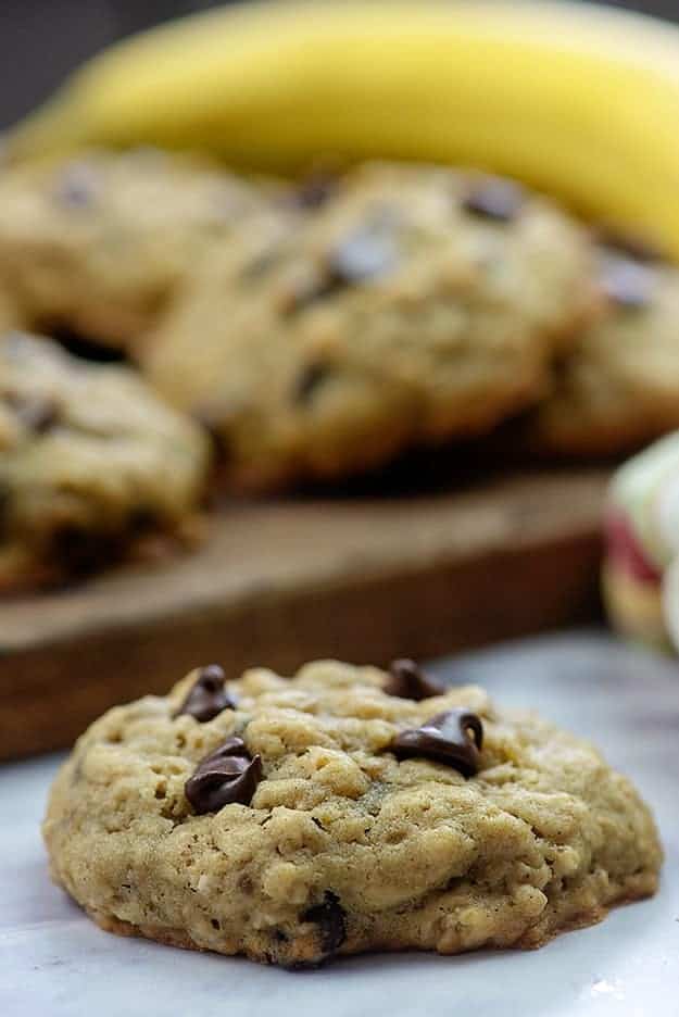 A close up of the top of a cookie with a plate of cookies in the background.