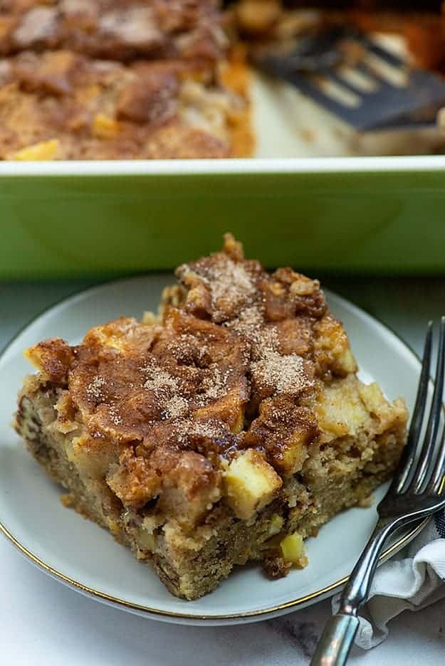 A plate of a piece of apple cake with a fork.