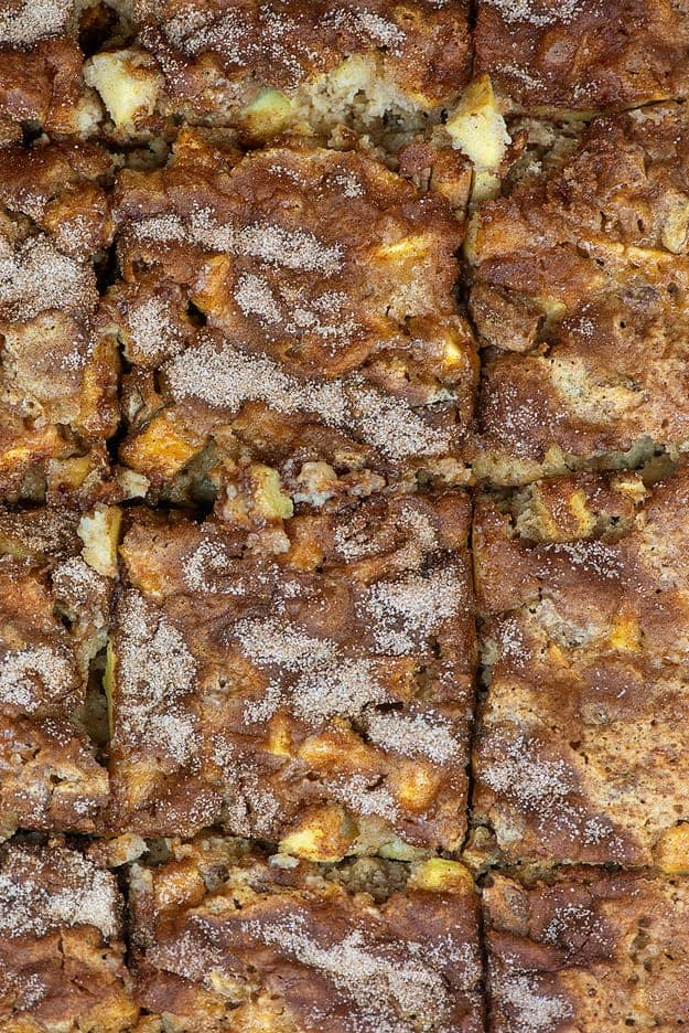 Top down view of apple cake cut into squares.