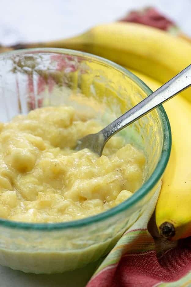 mashed bananas in glass bowl