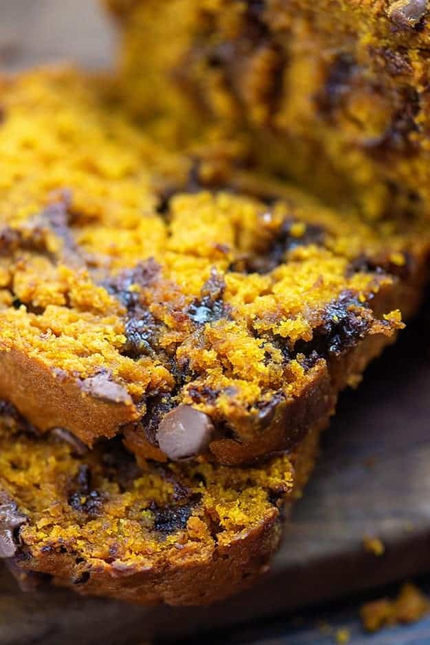 A close up of sliced pumpkin bread falling on top of itself.