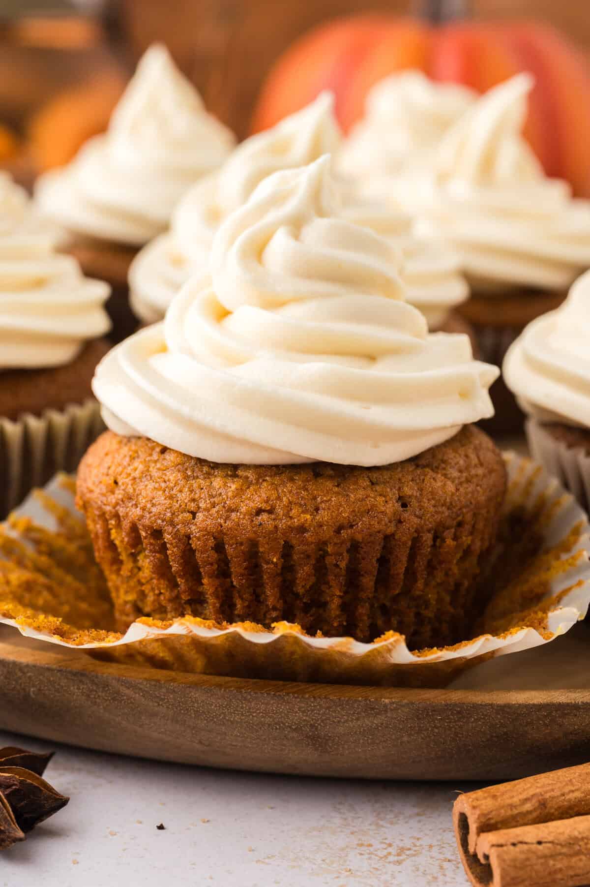 Pumpkin cupcakes topped with cream cheese frosting.