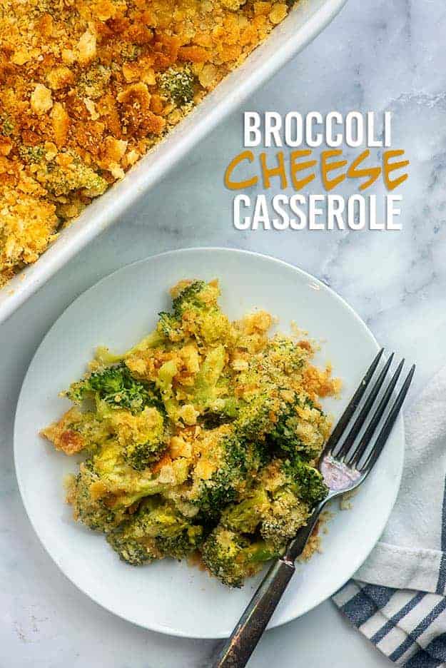 Broccoli and cheese on a small white plate with a fork.