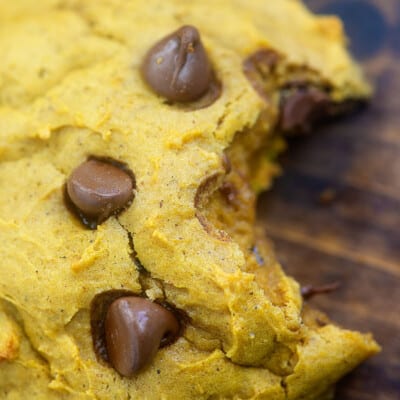 Close up of a bite taken out of a pumpkin cookie.