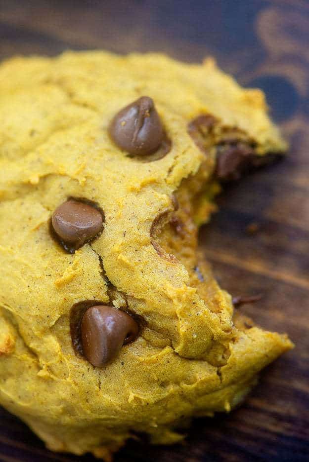 Close up of a bite taken out of a pumpkin cookie.