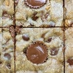 Close up of blondies cut into squares with a mini Reese's peanut butter cup in the center.