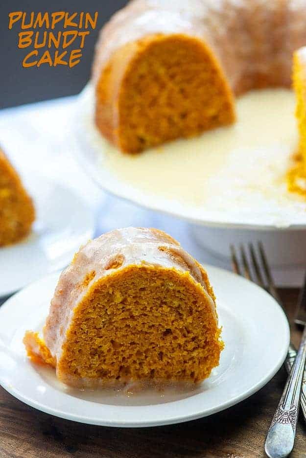 Sliced bundt cake on a plate in front of a cake stand.