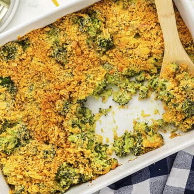 Baked broccoli and cheese casserole in white baking dish.