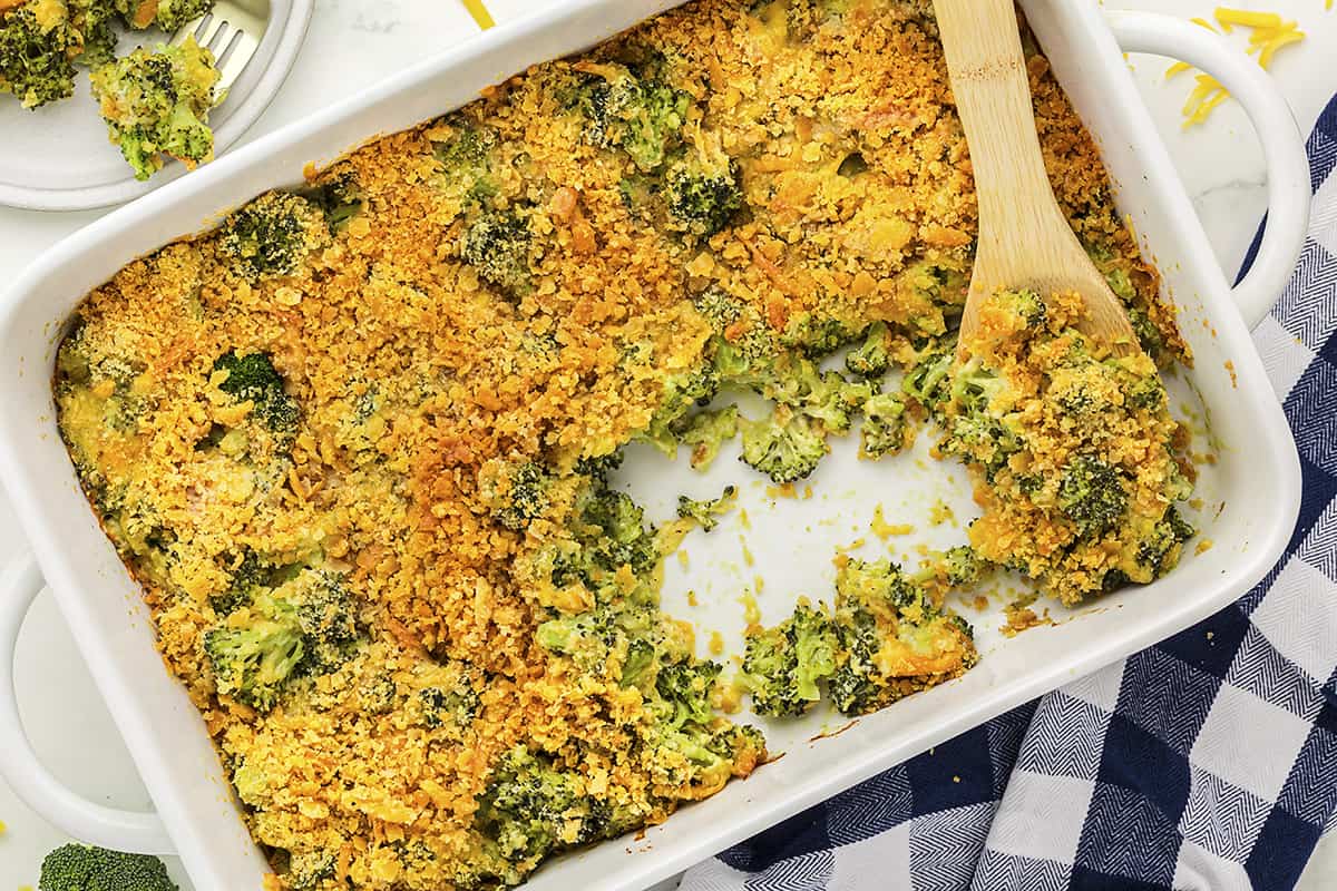 Baked broccoli and cheese casserole in white baking dish.