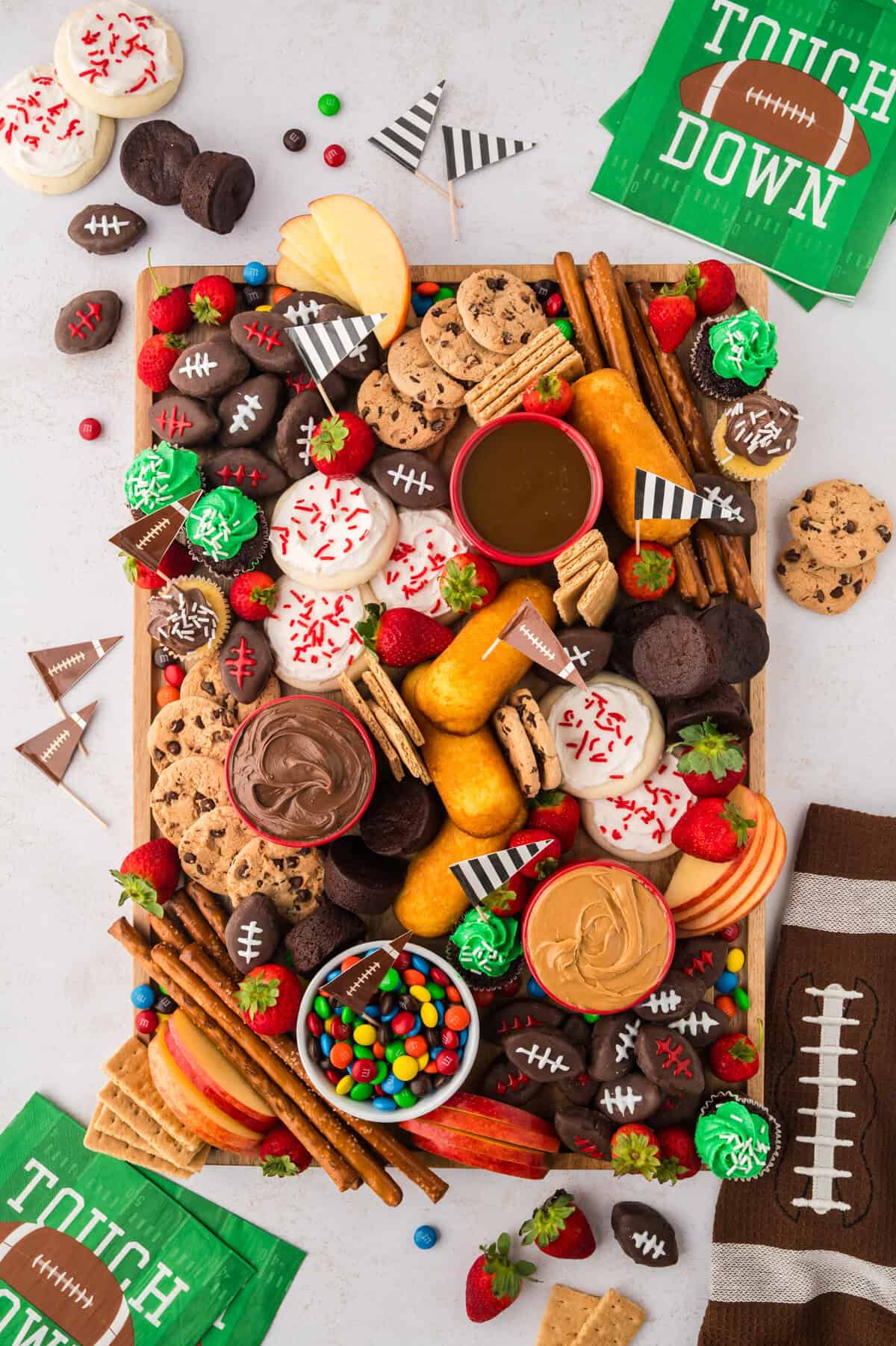 Football dessert board filled with sweets.