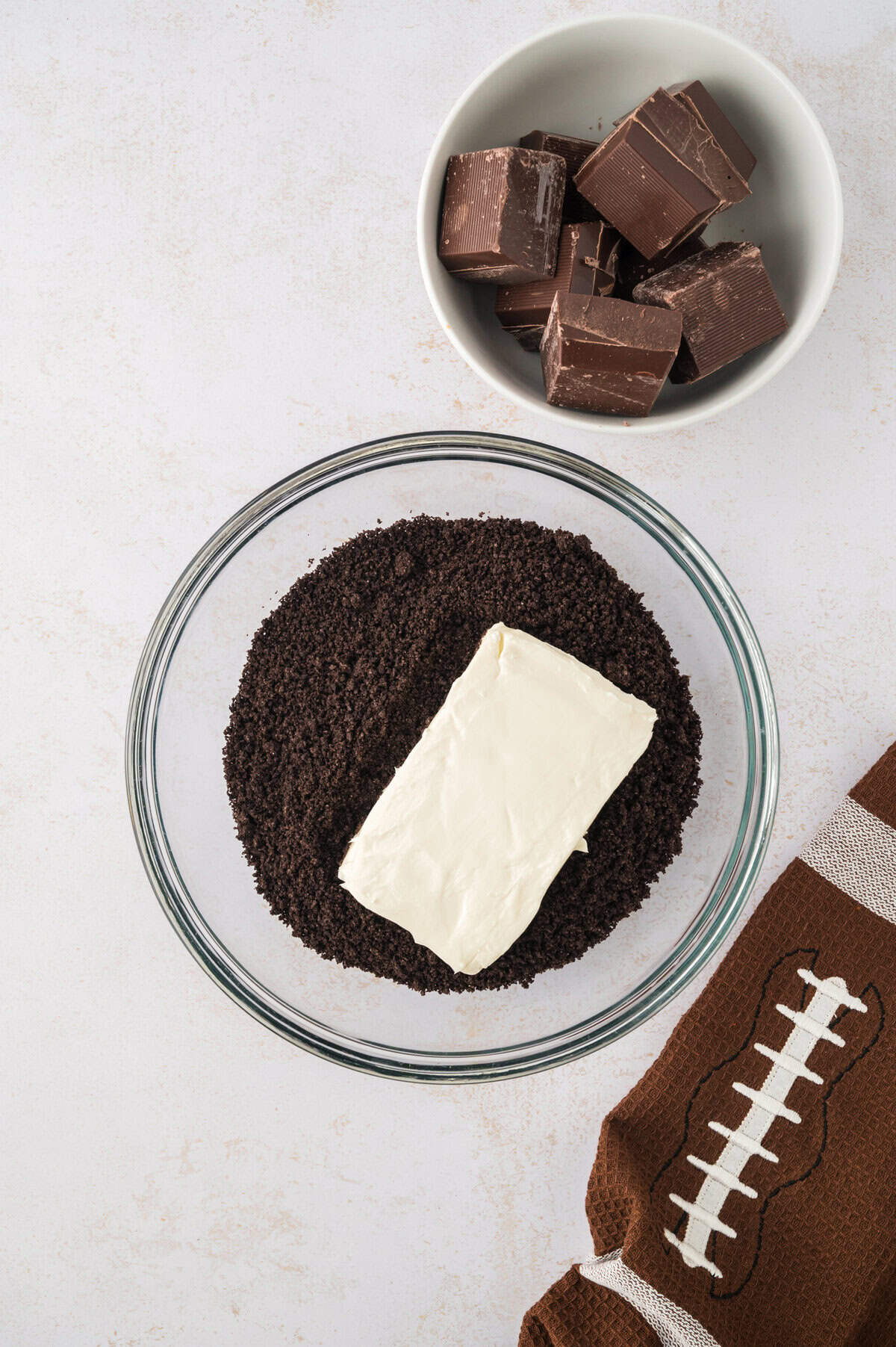Cream cheese and Oreo crumbs in mixing bowl.
