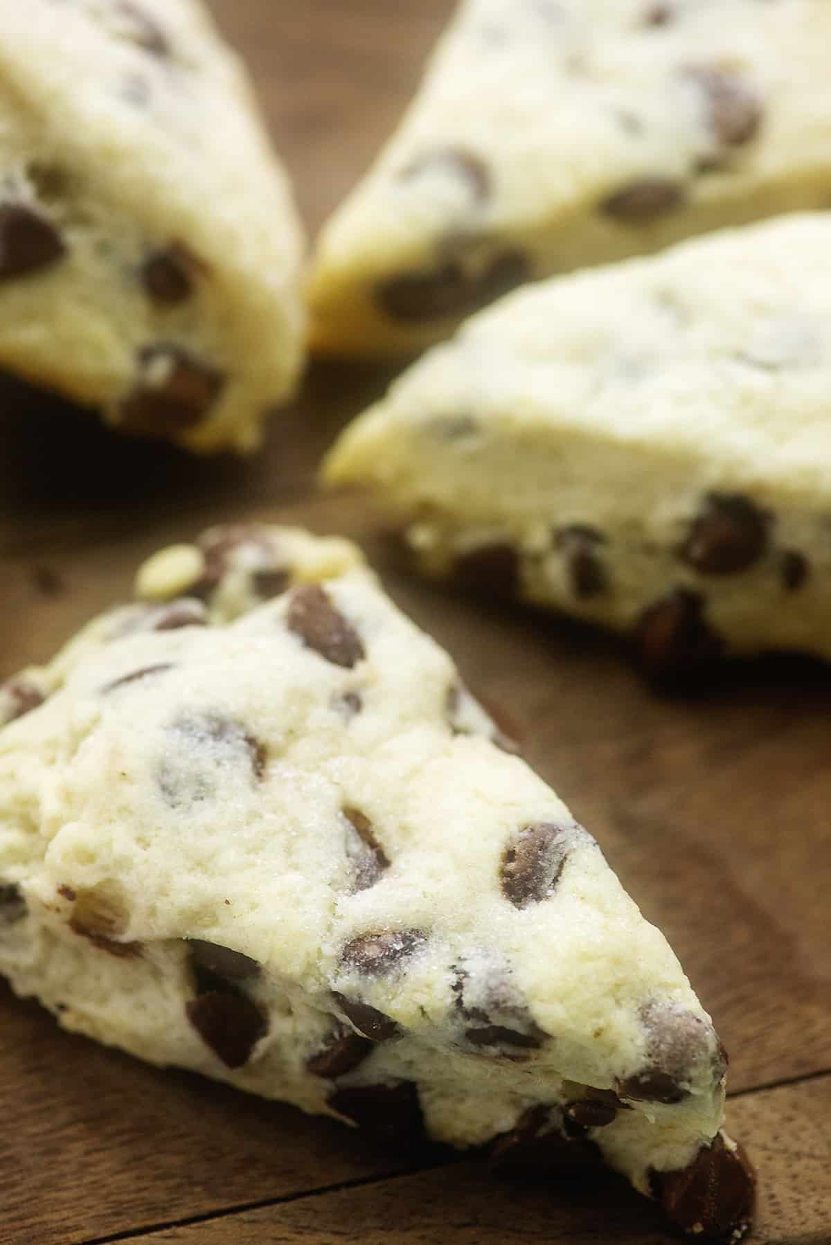 Chocolate chip scones on wooden board.