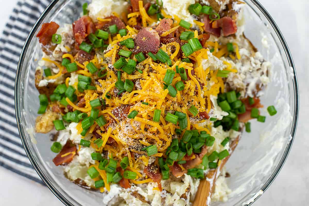 ingredients for loaded potato casserole in mixing bowl.