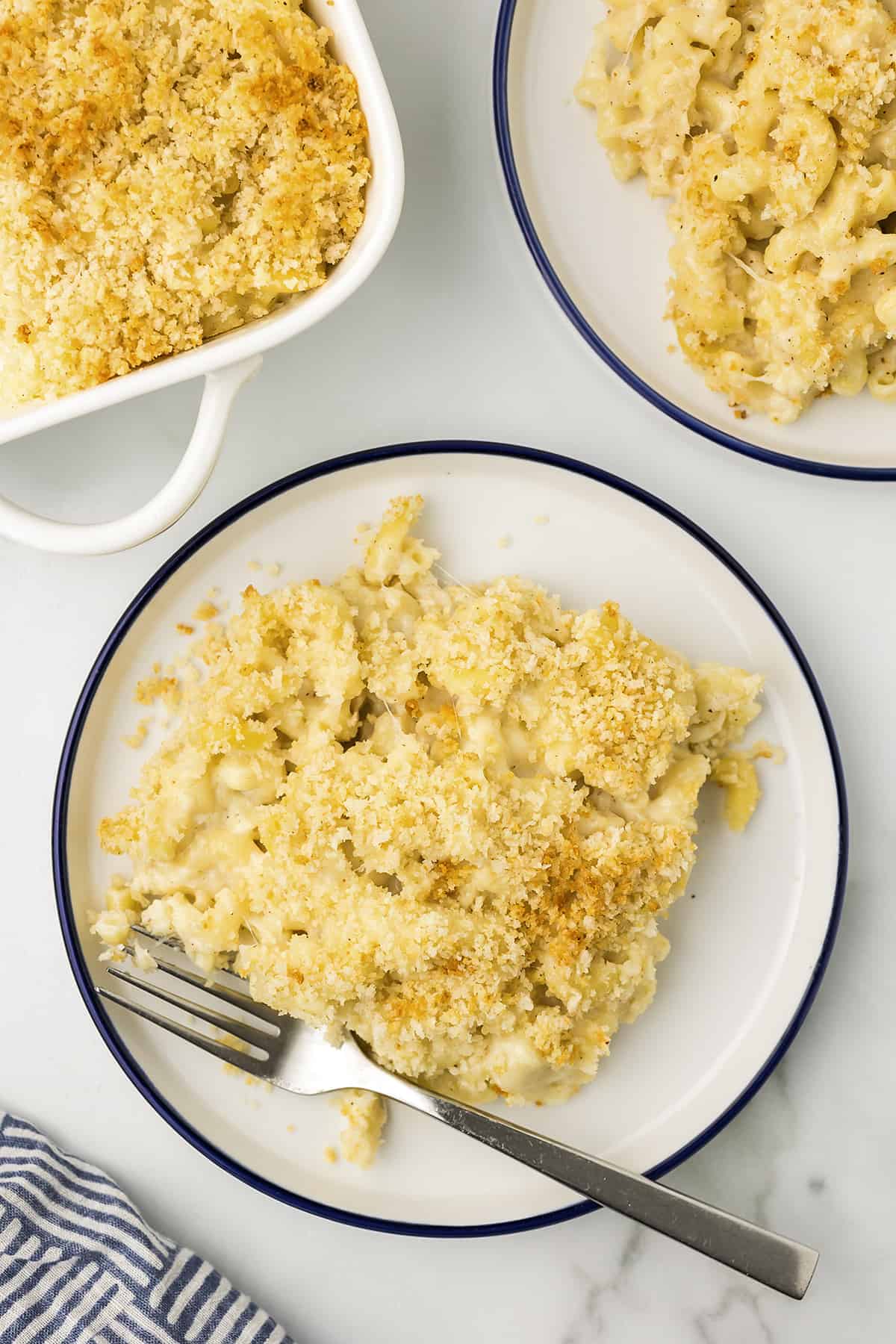 Mac and cheese recipe on white plate with fork.