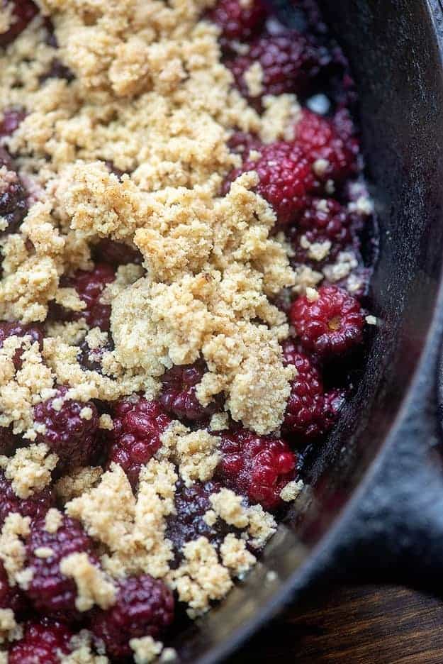 A top down view of blackberry cobbler in a cast iron skillet.