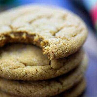 Stack of gingerbread cookies and the top one has a bite out of it.