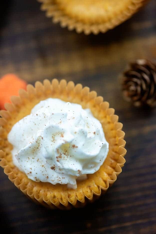 A top down view of low carb cheesecake bites on a table in the muffin wrapper.