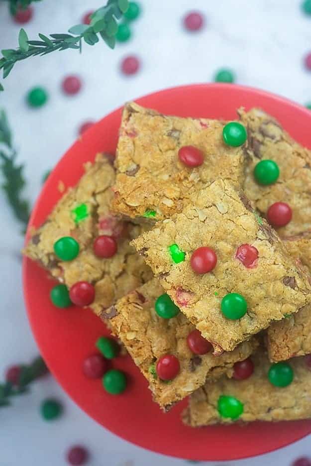 Stacked cookie squares on a red plate.