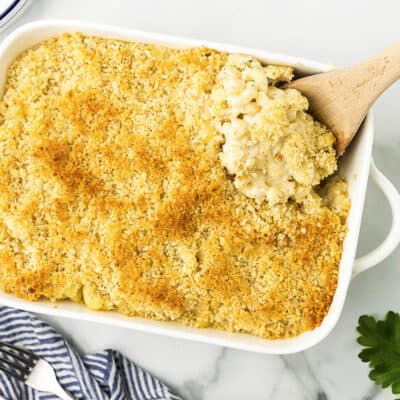 Baked mac and cheese in white casserole dish.