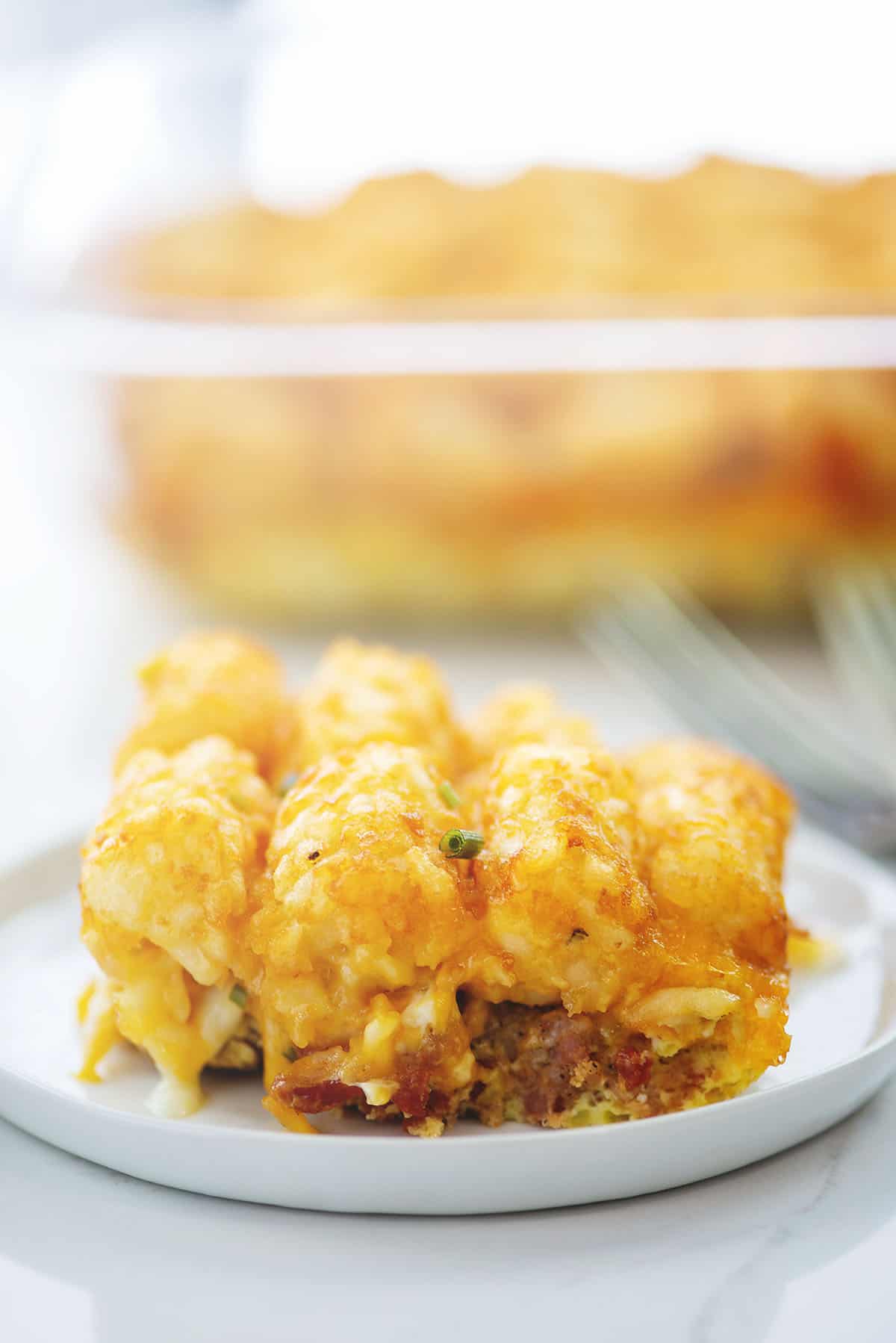 tater tot breakfast casserole on small white plate.