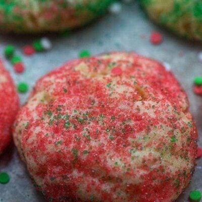 Several sugar cookies on a baking sheet.